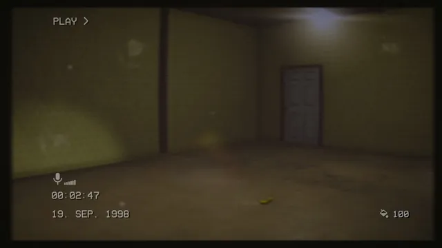 The Backrooms 1998 screenshot: an empty yellow-walled room with a white door and a flashlight beam, in grainy VHS footage