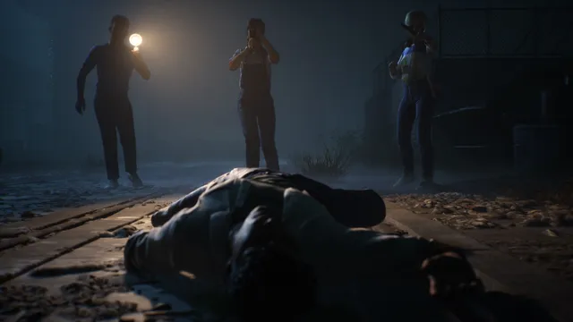 Three friends with a flashlight and a camera approaching a body lying on the ground at night