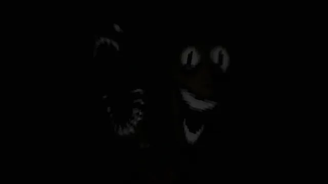 A dim grinning face with wide eyes and an open mouth looming out of the dark