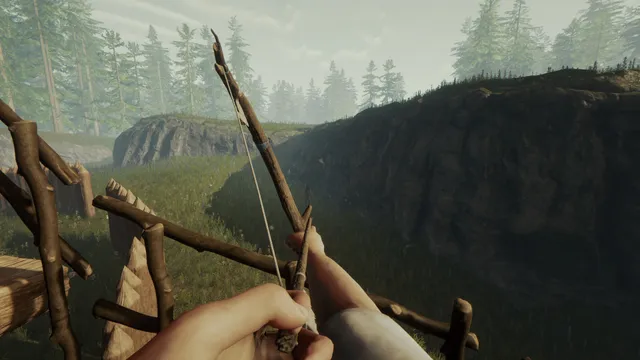 The Forest screenshot: drawing a crafted wooden bow at the edge of a camp above a forested valley