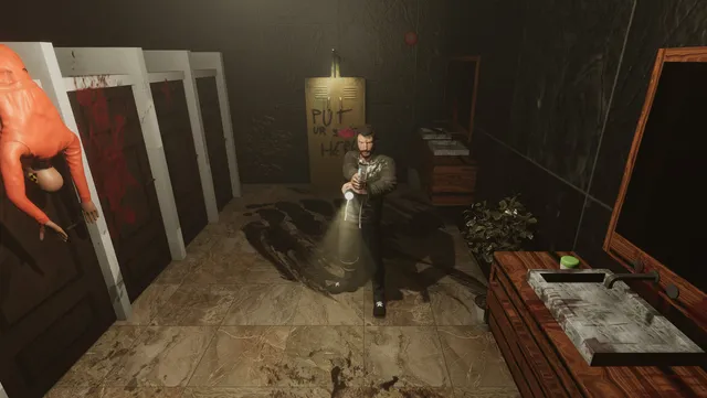 Alex shines a flashlight in a bloodstained hotel bathroom, a body in an orange jacket hanging over a stall door