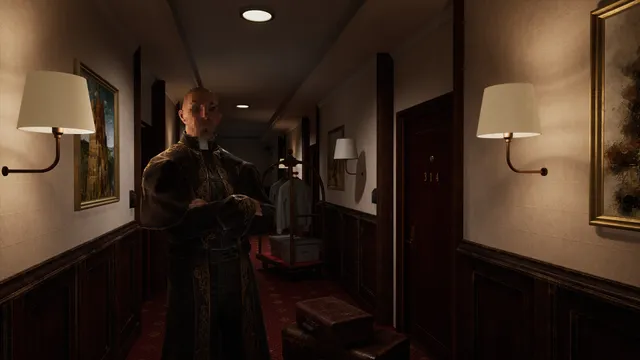 A priest in black robes stands with folded arms in a lamp-lit hotel hallway