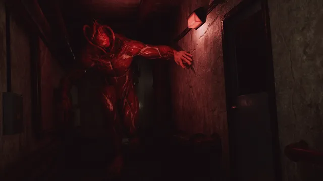 A red, skinless creature leans out into a dim hotel corridor lit by a single wall lamp