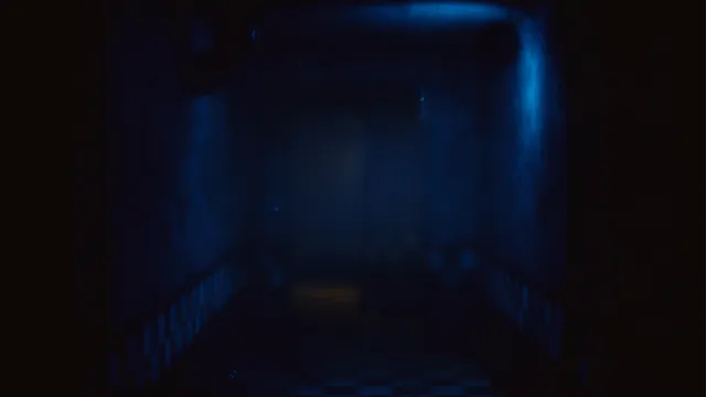 The Joy of Creation: Halloween Edition screenshot: a blue-lit corridor with checkered tiles fading into fog