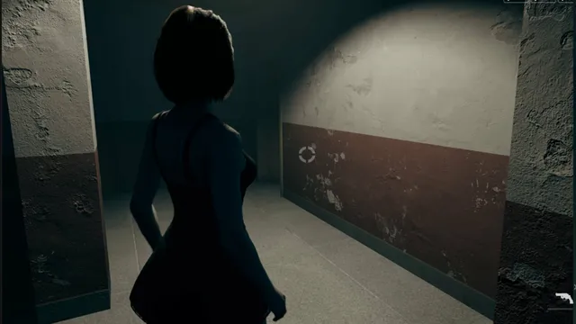 Jodi walks down a dark concrete corridor lit by a single lamp