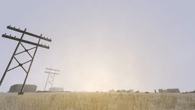 Leaning telegraph poles and low ruins on a grassy island under a white, misty sky