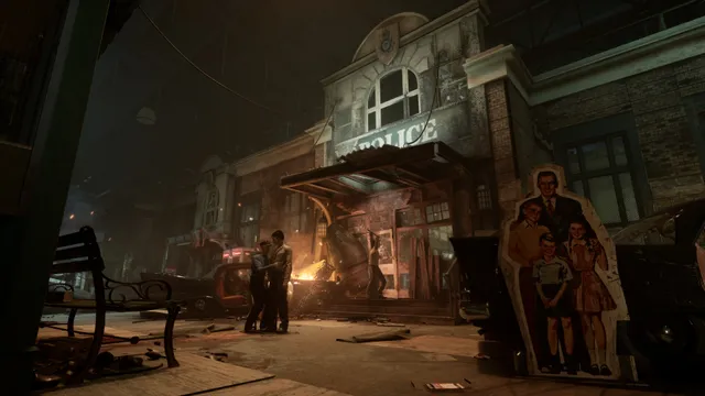 The Outlast Trials screenshot: a staged town street at night with a burning car, a police station facade and a cut-out family billboard