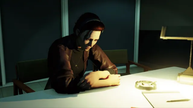 Lorraine sits hunched at a table under a desk lamp with an ashtray in front of her