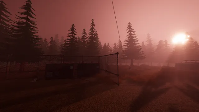 The Radio Tower screenshot: a chain-link fence and pine forest under a hazy red sky