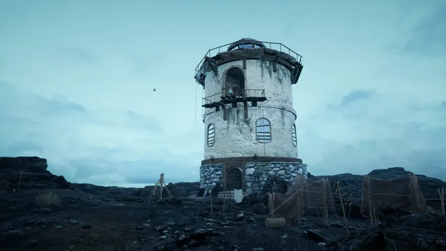 The Shore screenshot: a weathered round white tower with a wooden balcony stands on dark rocky ground among fishing nets