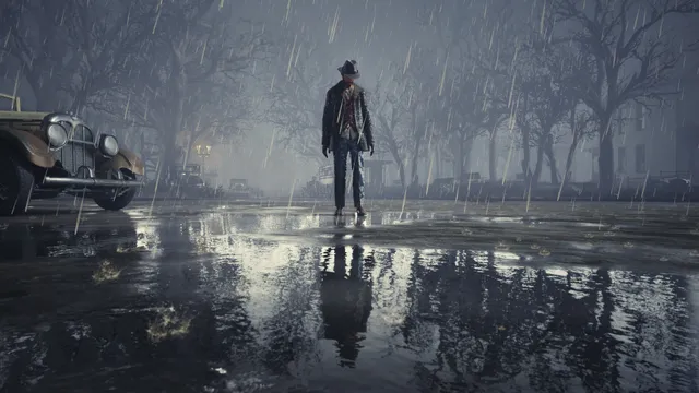 The Sinking City Remastered screenshot: a man in a hat stands in the rain on a wet street beside an old car