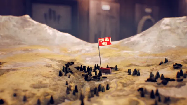 A model of the snowy valley with a red You Are Here flag over the hotel
