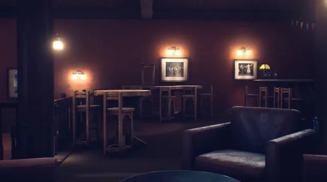 The hotel's empty bar at night, wall lamps glowing over bare wooden tables and a leather armchair