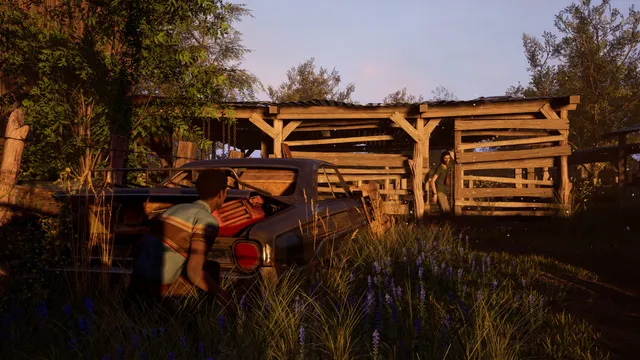 The Texas Chain Saw Massacre screenshot: a victim searches a car boot in tall grass while a family member walks by a shed