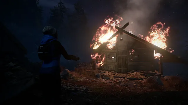 The mother reaches toward a wooden cabin in flames in the dark forest
