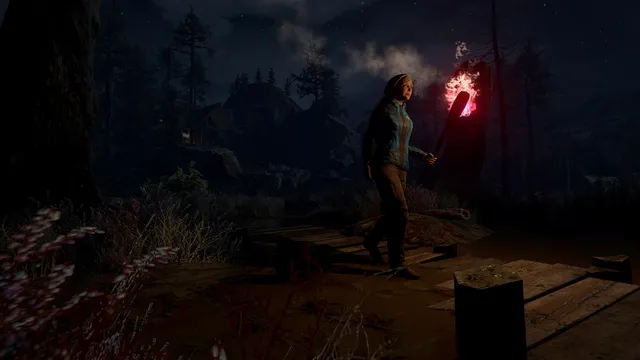 The mother crosses a wooden boardwalk at night carrying a flaming torch