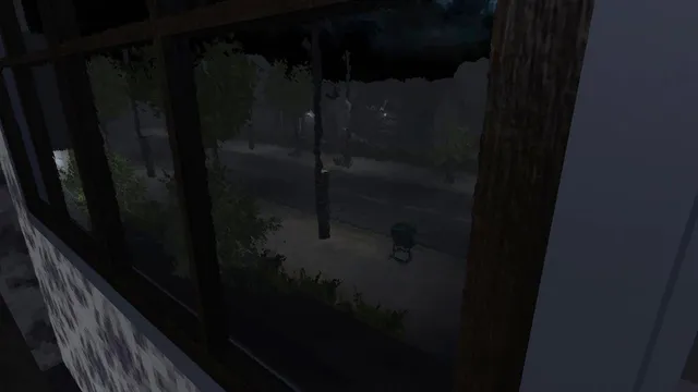 Looking out of a dark house window at a deserted night street under heavy trees