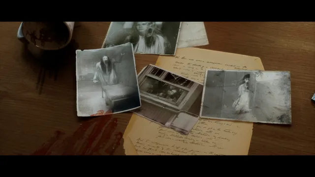 Old photographs of a pale girl in white, spattered with blood, on a table