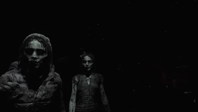 Two pale, grey figures looming out of complete darkness