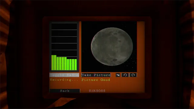 The probe's orange cockpit screen showing a grey cratered moon, a radio meter recording and the words Picture Good