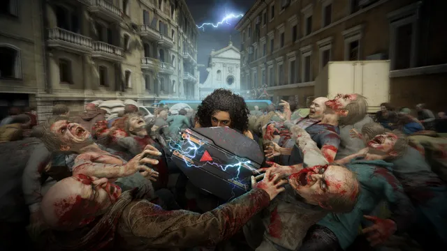 World War Z screenshot: a survivor braces behind an electrified riot shield as a mass of bloody zombies presses in